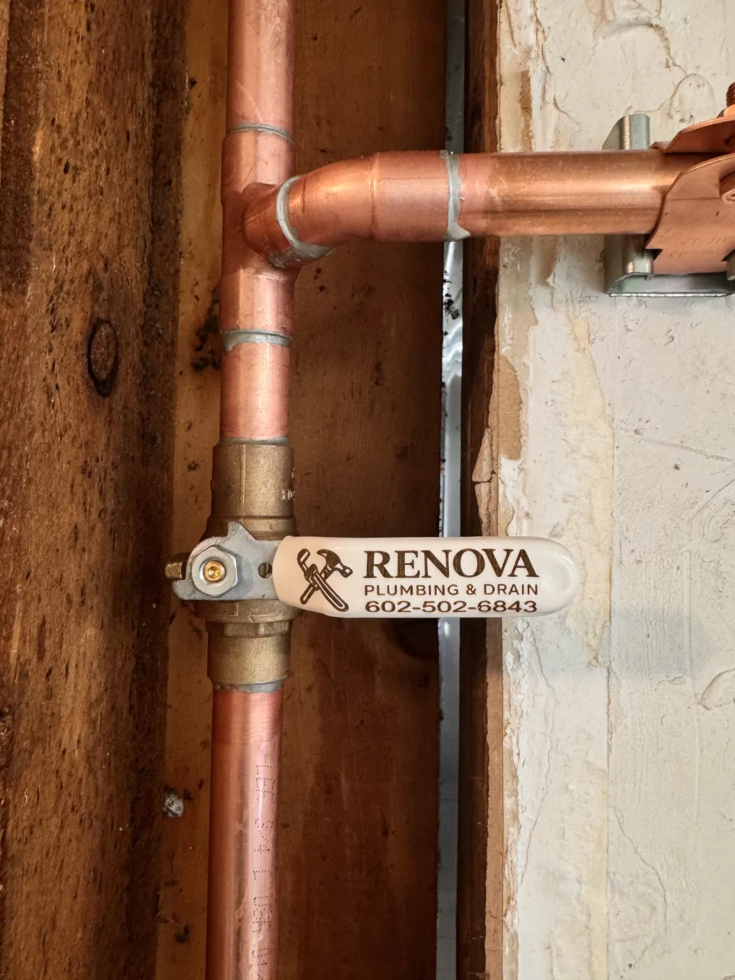 New copper water supply line with a Renova Plumbing & Drain tagged shutoff valve